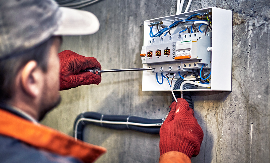 Commercial technician working on Electrical box