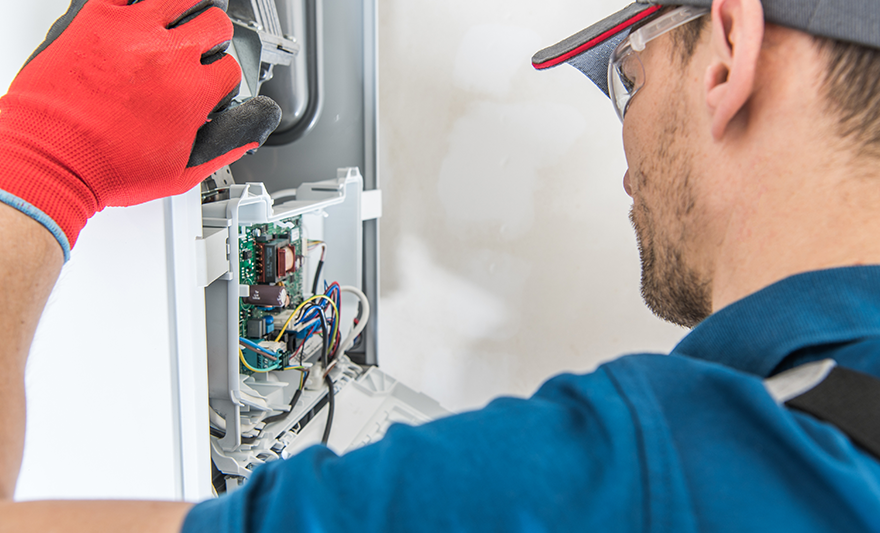 Residential Furnace Repair technician in a panel