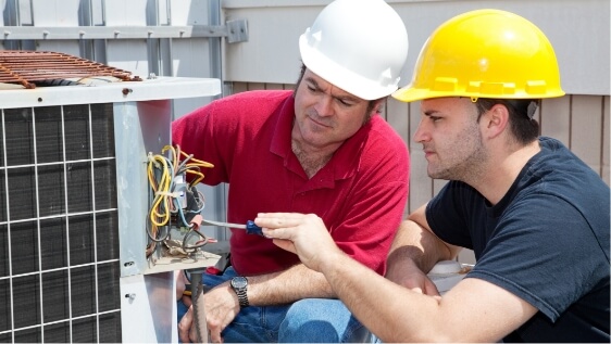 HVAC technician training someone on wiring