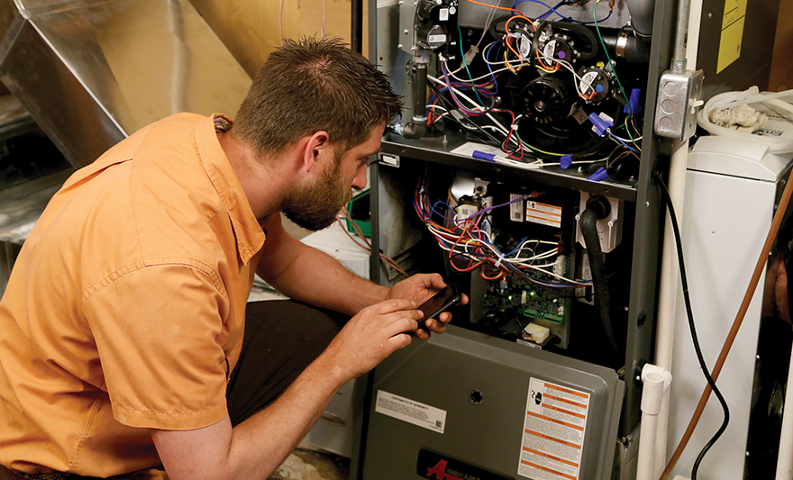 technician conducting furnace maintenance