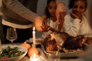 family gathers for thanksgiving meal