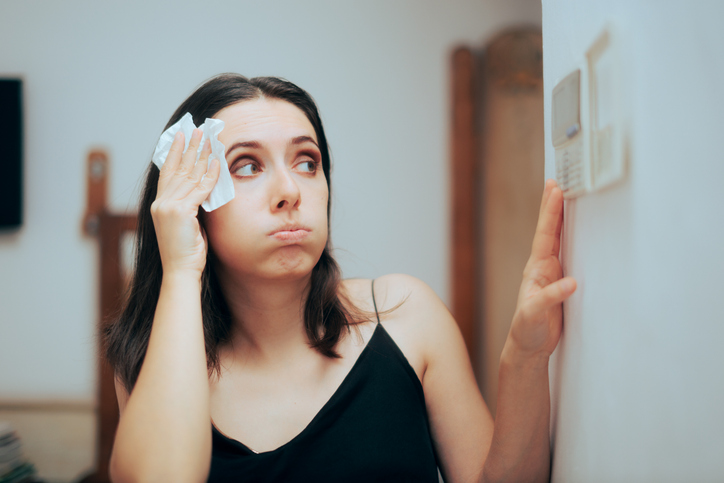 Person adjusting temperature from the AC settings