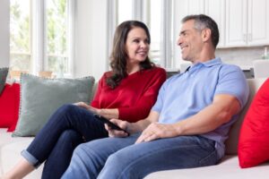 Couple sits on sofa together