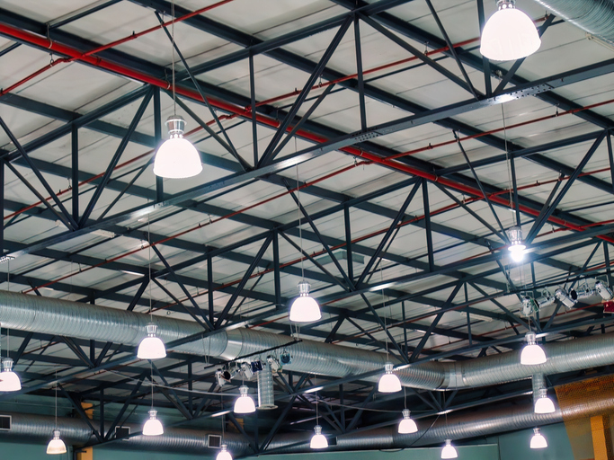 industrial ceiling with lights and metal beams at a venue