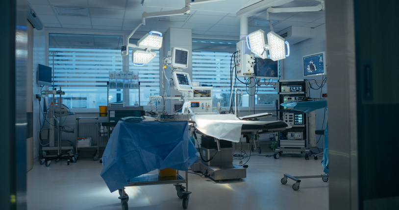 Shot with Empty Operating Room with Advanced Surgical Lights and Modern Medical Equipment and Sterile Preparation for Upcoming Surgical Procedures. Photo Without People in Modern Clinic