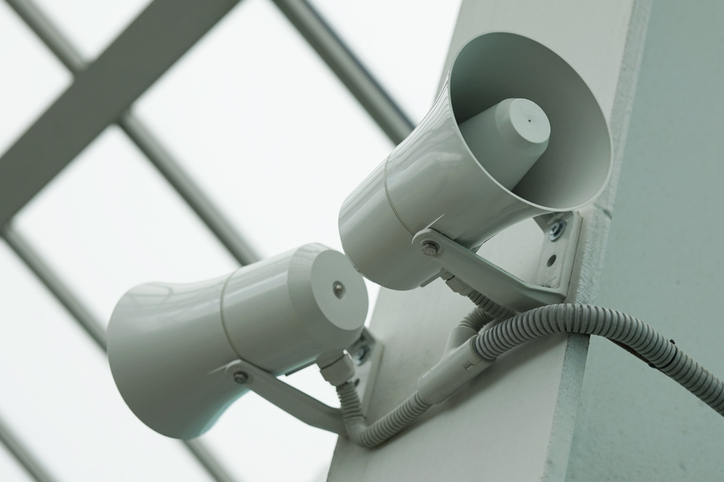 A pair of megaphones on the wall of the building.